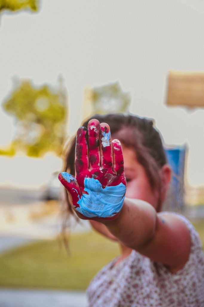 girl-hand-with-red-and-blue-paint